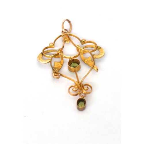 40 - EDWARDIAN 9CT GOLD PERIDOT & SEED PEARL pendant, 5.0cm long x 3.0cm wide of scrolling ribbon and flo... 