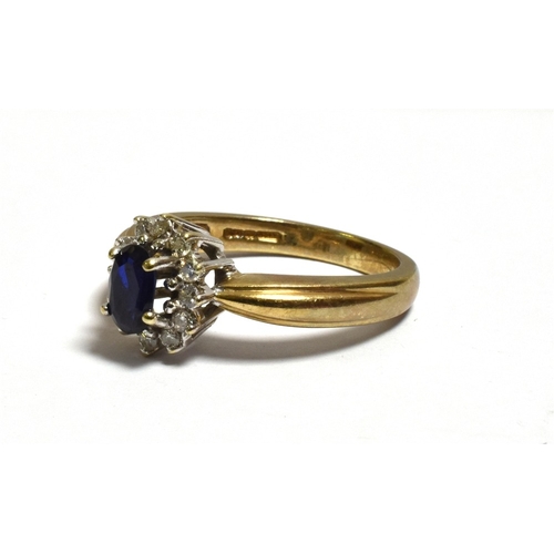 43 - SAPPHIRE & DIAMOND HALO CLUSTER RING claw set with an oval sapphire, estimated 0.60 carats surrounde... 