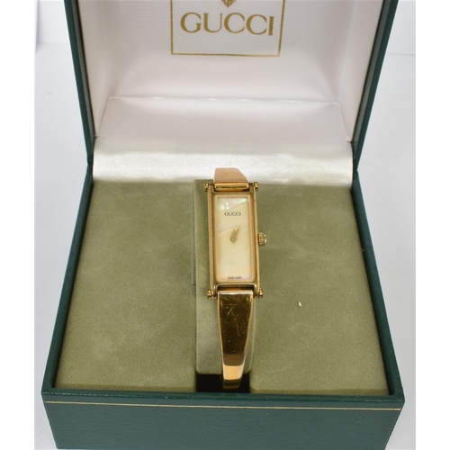 65 - LADIES GUCCI WRISTWATCH 12.2mm wide rectangular gold plated case, signed Gucci reference 1500, mothe... 