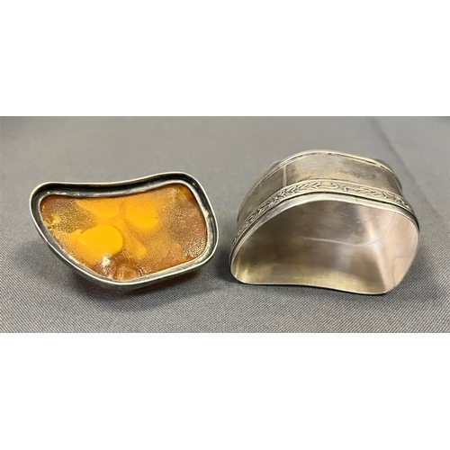 115 - AMBER TOPPED SILVER TRINKET BOX standing 4.5cm tall x 5.3cm long, with a band of embossed floral and... 