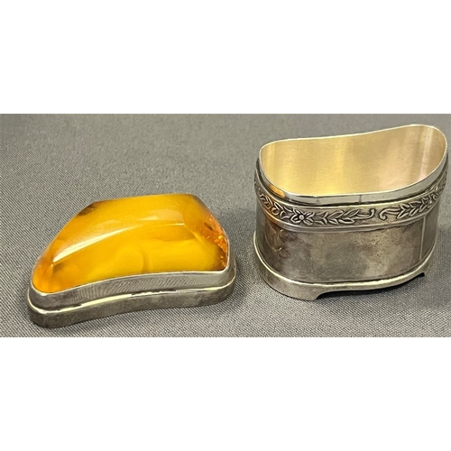 115 - AMBER TOPPED SILVER TRINKET BOX standing 4.5cm tall x 5.3cm long, with a band of embossed floral and... 