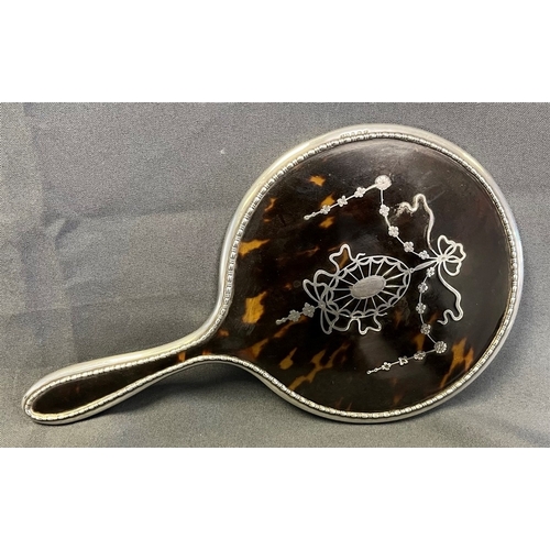 126 - EDWARDIAN SILVER & TORTOISEHELL HAND mirror, decorated with silver pique floral and swag motifs, wit... 