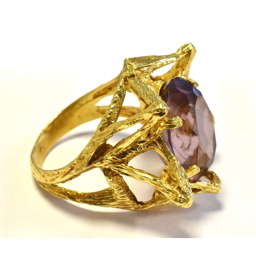 14 - 14CT GOLD & PURPLE PASTE STONE RING in an asymmetrical star shaped design decorated with textured en... 