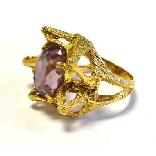 14 - 14CT GOLD & PURPLE PASTE STONE RING in an asymmetrical star shaped design decorated with textured en... 