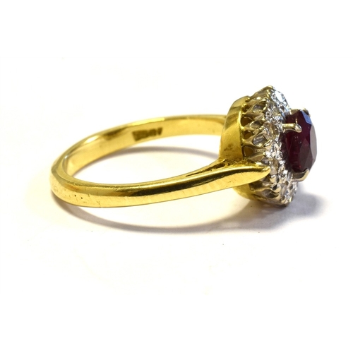 15 - 18CT GOLD RUBY & DIAMOND CLUSTER RING 10.6mm diameter, halo style cluster, set with an oval ruby, of... 