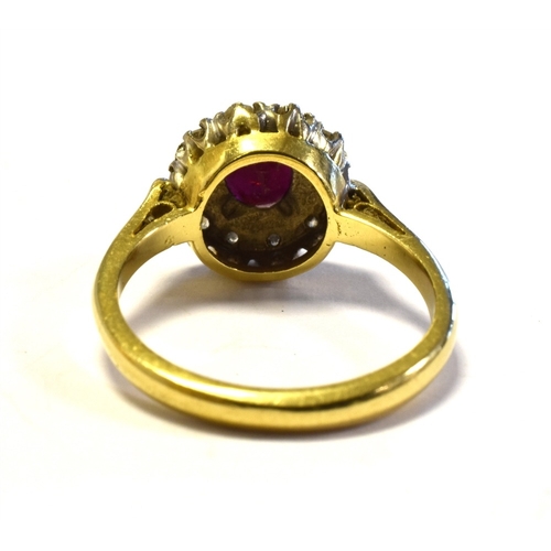 15 - 18CT GOLD RUBY & DIAMOND CLUSTER RING 10.6mm diameter, halo style cluster, set with an oval ruby, of... 