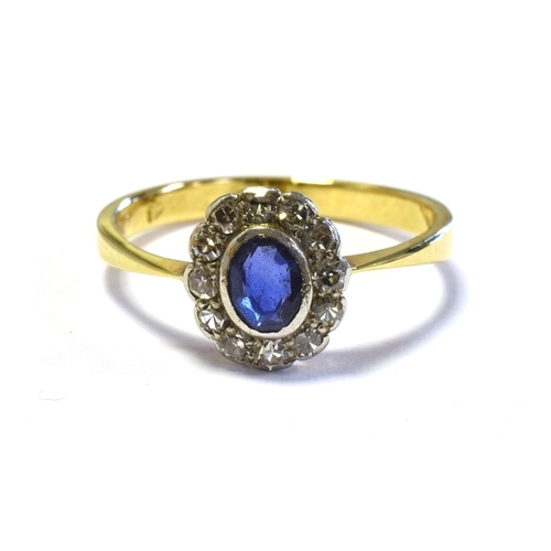 21 - 18CT GOLD SAPPHIRE & DIAMOND RING 9.3 x 8.6mm oval cluster, with central bezel set oval sapphire, es... 