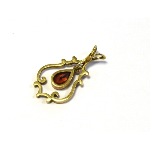 31 - 9CT GOLD GARNET PENDANT 3.2cm long x 1.8cm wide, with articulated pear shaped pyrope garnet to centr... 