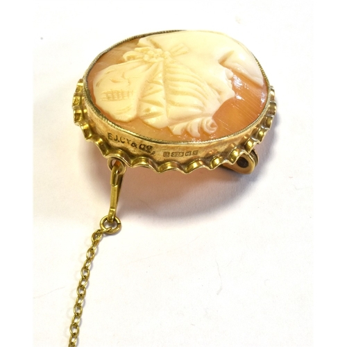 43 - SHELL CAMEO BROOCH SET IN 9CT GOLD depicting a classical female with bonnet, bezel set in a scallope... 