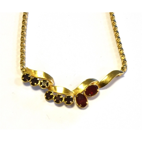 68 - 18CT GOLD GARNET SET LAVALIER 43cm long, with a claw set garnet and red paste stone centre piece, se... 