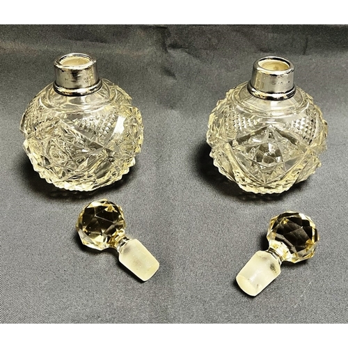 114 - ANTIQUE SILVER MOUNTED SCENT BOTTLES a pair, standing 13cm tall with cut crystal bases and silver mo... 