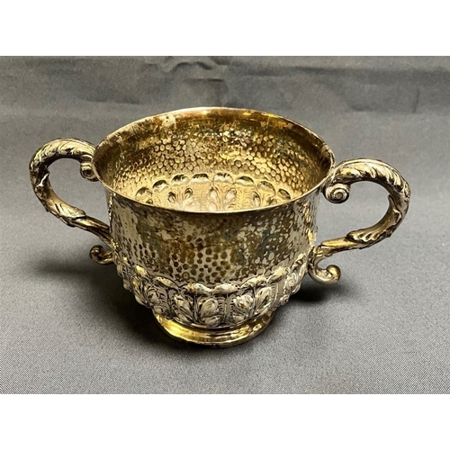 118 - EDWARDIAN STERLING SILVER BOWL standing 8.7cm tall with hammered and foliate embossed decoration to ... 