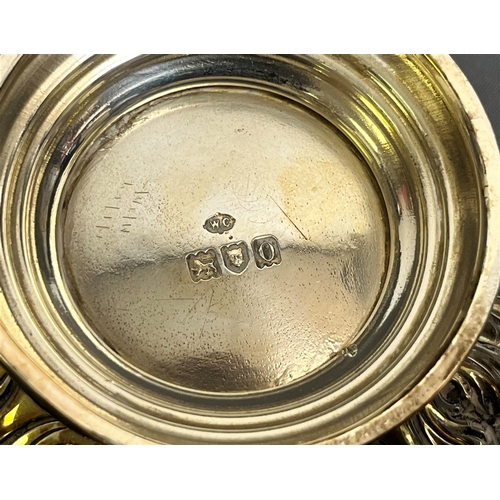 118 - EDWARDIAN STERLING SILVER BOWL standing 8.7cm tall with hammered and foliate embossed decoration to ... 