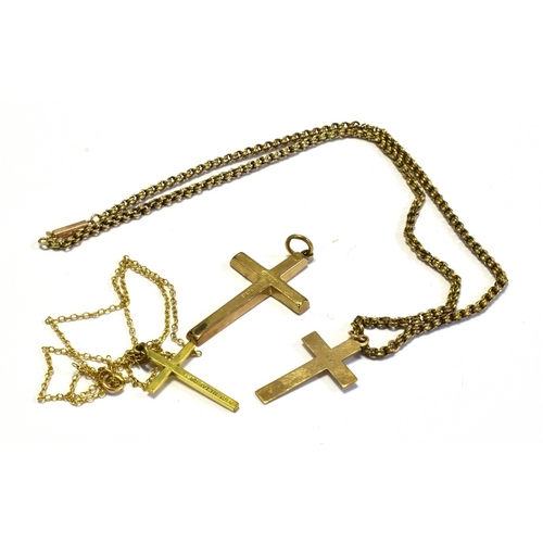 16 - 9CT GOLD LATIN CROSSES & CHAINS one cross 4.5cm long with engraved decoration, one with oblique engr... 