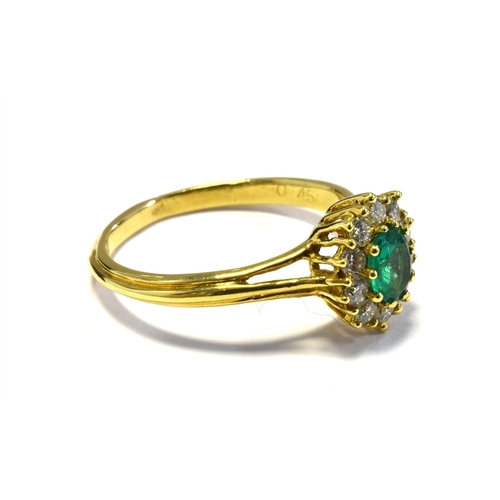 2 - 18CT EMERALD & DIAMOND RING 10.6 x 9.5mm oval cluster, set with an oval emerald, reported as 0.45 ca... 