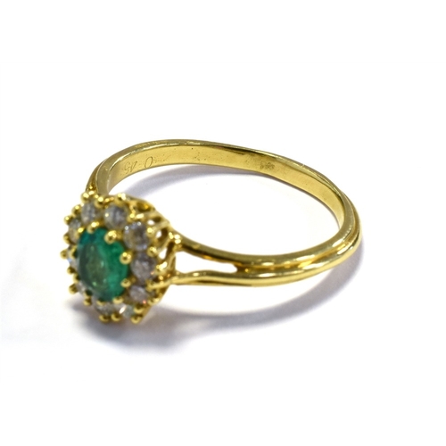 2 - 18CT EMERALD & DIAMOND RING 10.6 x 9.5mm oval cluster, set with an oval emerald, reported as 0.45 ca... 