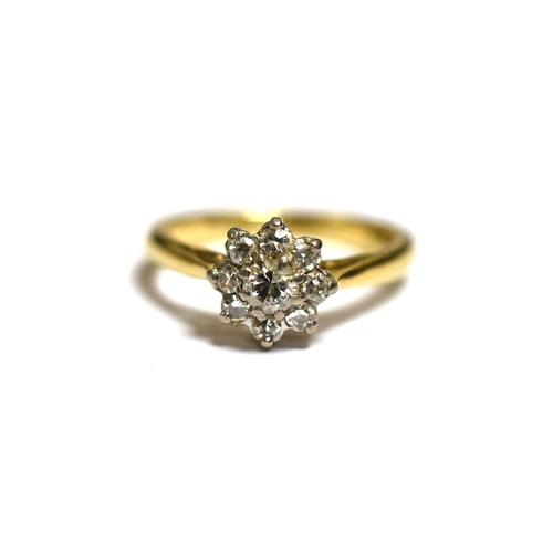 33 - 18CT GOLD & DIAMOND FLORAL CLUSTER RING set with one round brilliant cut and eight single cut diamon... 