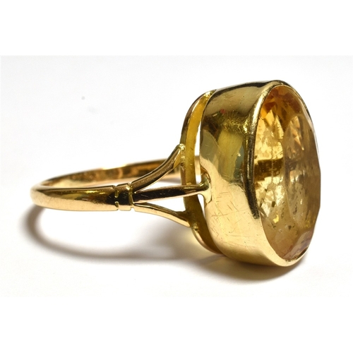 36 - 9CT GOLD & CITRINE DRESS RING with deep collet set oval citrine, estimated 10.1 carats, ring size U.... 