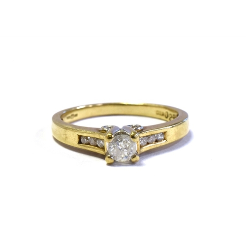 40 - 9CT GOLD DIAMOND SOLITAIRE RING central four claw set round brilliant cut diamond, flanked by channe... 