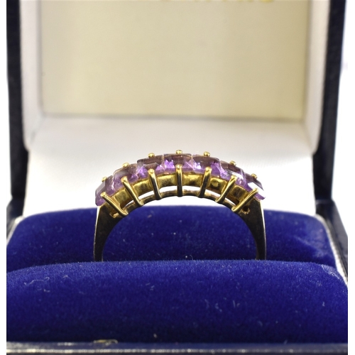 46 - 9CT GOLD & AMETHYST SEVEN STONE RING claw set with carre cut amethysts, ring size P 1/2, stamped '37... 