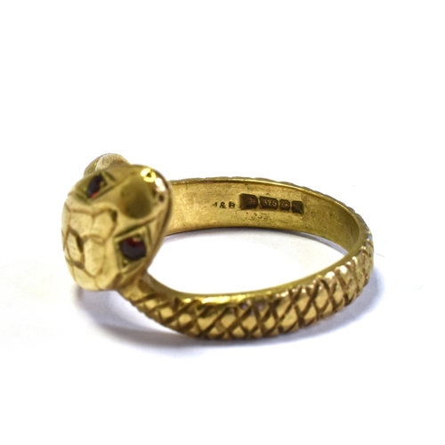 62 - 9CT GOLD SNAKE RING depicting a coiled snake, with grain set red stone eyes.  Ring size T.  Hallmark... 