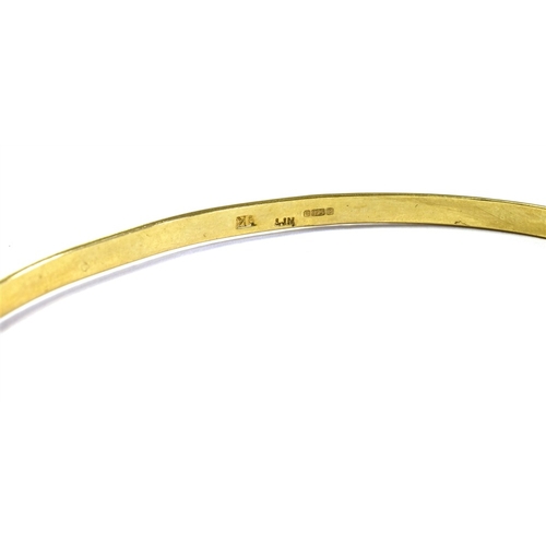 64 - 9CT GOLD BANGLE 3.2mm wide engraved bangle, hallmarked Sheffield 1977.  Weight 4.7 grams.