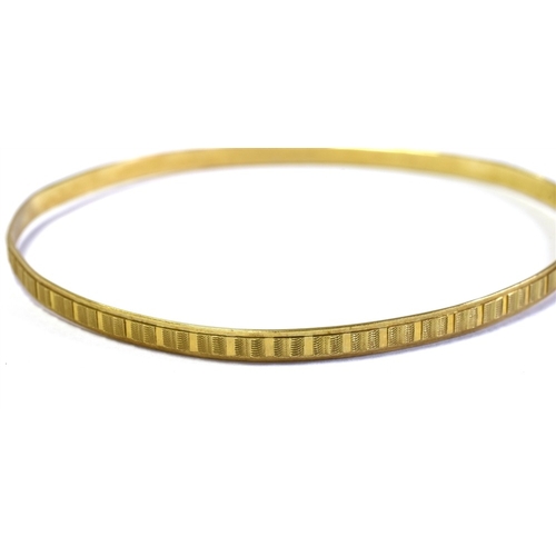 64 - 9CT GOLD BANGLE 3.2mm wide engraved bangle, hallmarked Sheffield 1977.  Weight 4.7 grams.