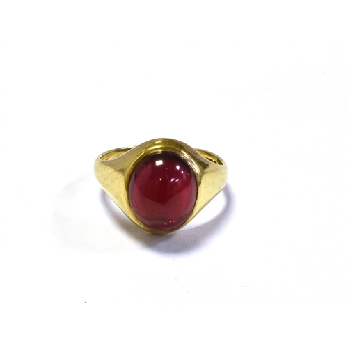 74 - 9CT GOLD SYNTHETIC RUBY RING a bezel set oval cabochon cut synthetic ruby, within integral shank, ha... 