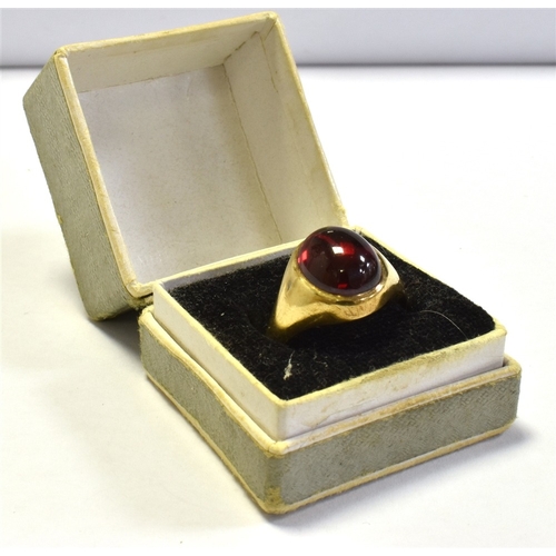 74 - 9CT GOLD SYNTHETIC RUBY RING a bezel set oval cabochon cut synthetic ruby, within integral shank, ha... 