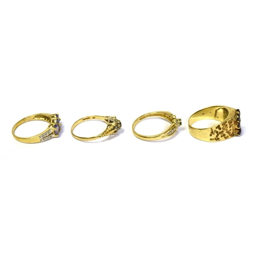 85 - 9CT GOLD & GEM SET RINGS to include a tanzanite and diamond three stone ring, a pyrope garnet dress ... 