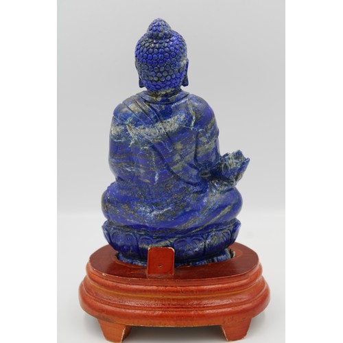 54 - Hand-carved Chinese Buddha statue in lapis lazuli stone, complete with a wooden stand.

around 22cm ... 