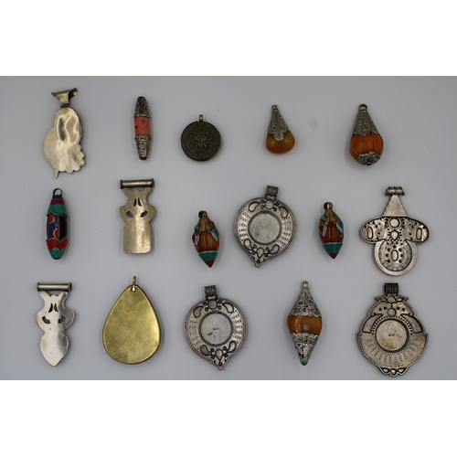 251 - Assorted collection of Tibetan/Nepali pendants crafted from white and yellow metals. 

x16