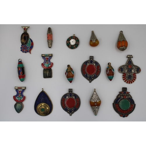 251 - Assorted collection of Tibetan/Nepali pendants crafted from white and yellow metals. 

x16