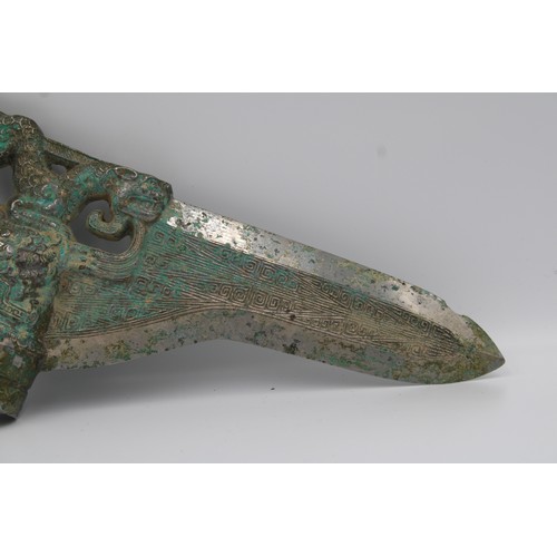 66 - Shang Bronze dagger with dragon and phoenix decoration.

Around 25.5cm long