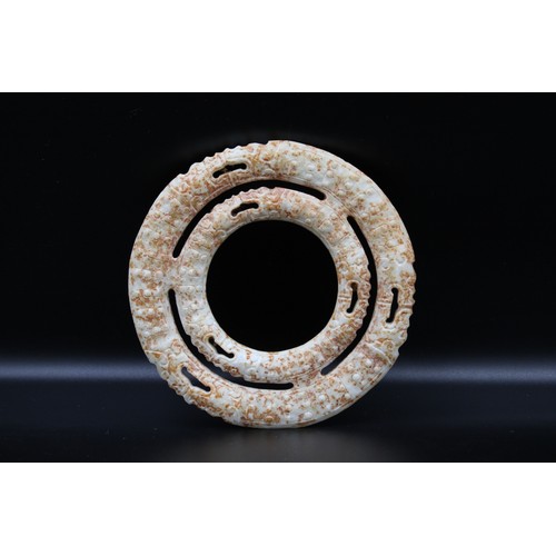 71 - Two Chinese conjoined jade russet rings depicting dragons.

diameter 11.5cm