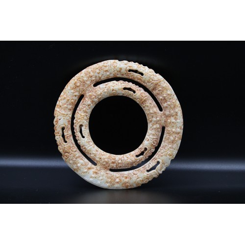 71 - Two Chinese conjoined jade russet rings depicting dragons.

diameter 11.5cm