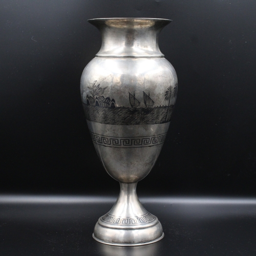 86 - This is an exceptionally large Iraqi silver niello vase adorned with intricate decorations depicting... 