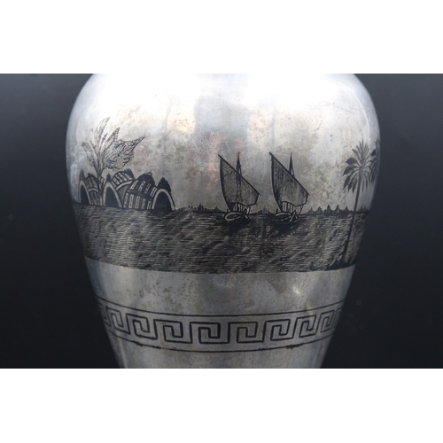 86 - This is an exceptionally large Iraqi silver niello vase adorned with intricate decorations depicting... 