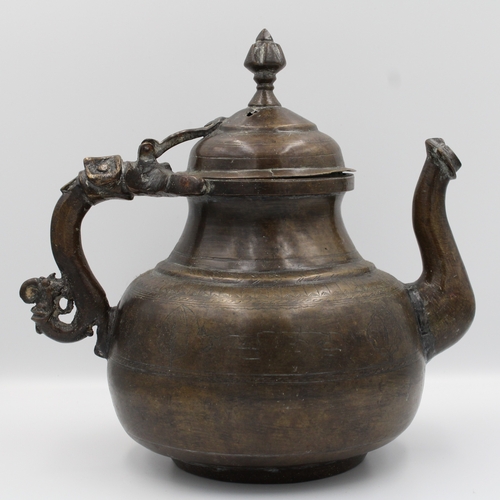 88 - 19th Century Indian Mughal Bronze Teapot with Intricate Carvings.

Roughly 26cm