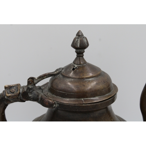 88 - 19th Century Indian Mughal Bronze Teapot with Intricate Carvings.

Roughly 26cm