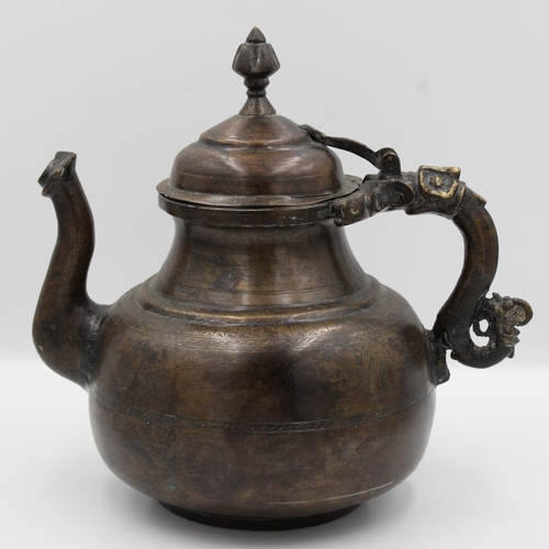 88 - 19th Century Indian Mughal Bronze Teapot with Intricate Carvings.

Roughly 26cm