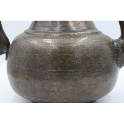 88 - 19th Century Indian Mughal Bronze Teapot with Intricate Carvings.

Roughly 26cm