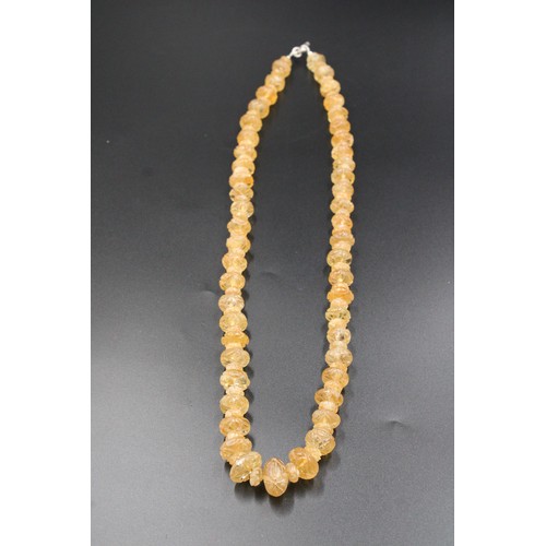 296 - Exquisite crystal necklace adorned with intricate carvings.