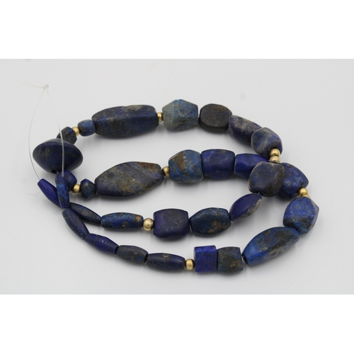 294 - Lapis lazuli necklace, measuring 33 cm in length, adorned with intricate yellow metal beads for adde... 