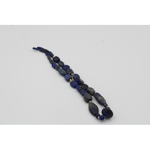 294 - Lapis lazuli necklace, measuring 33 cm in length, adorned with intricate yellow metal beads for adde... 