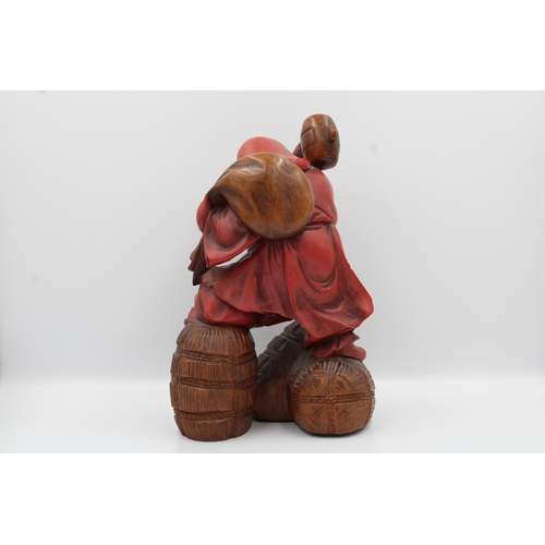 39 - A Japanese figurine, possibly made of wood or hard resin, dating from the late 19th century (1960s),... 