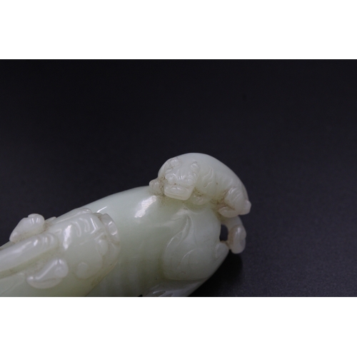 46 - This stunning Chinese jade sculpture portrays a mythical lion with its cub, showcasing intricate det... 