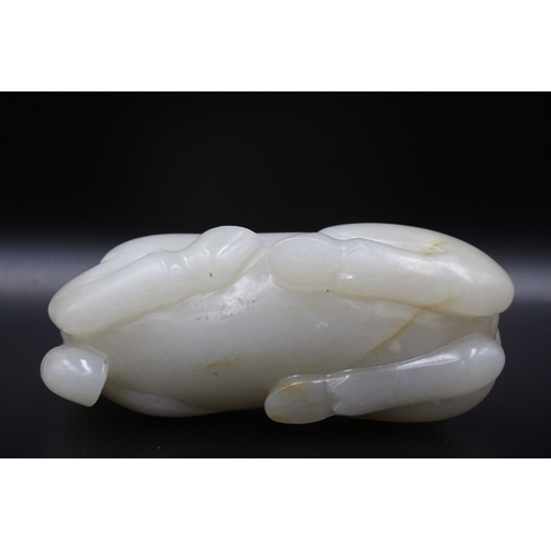 47 - This Chinese white jade sculpture from the Qing Dynasty, dating back to the 19th century, depicts a ... 