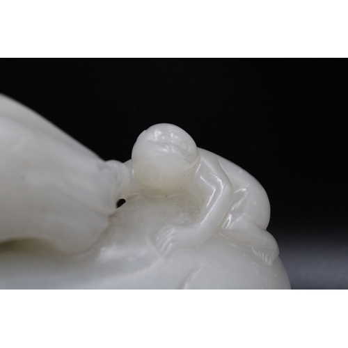 47 - This Chinese white jade sculpture from the Qing Dynasty, dating back to the 19th century, depicts a ... 