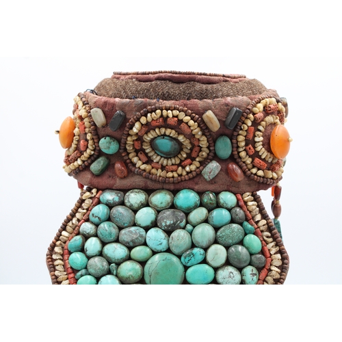 246 - Elegant Tibetan Hat: Adorned with Turquoise, Coral, Amber, and Agate

This Tibetan hat is a masterpi... 